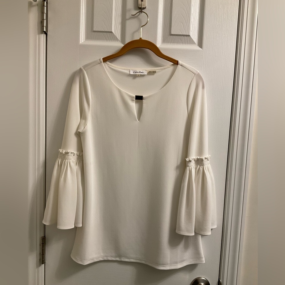 Calvin Klein white blouse, ruffle sleeve with gold accent